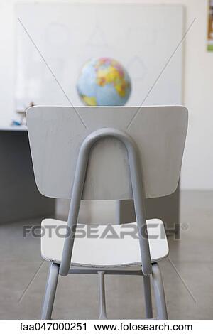 Chair in classroom, globe in background View Large Photo Image Stock Image - Chair in classroom, globe in background. Fotosearch