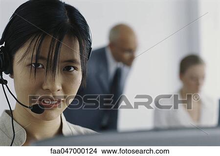 Picture - Customer service representative wearing headset. Fotosearch