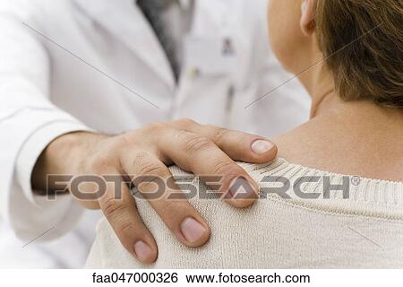 Doctor's hand on patient's shoulder View Large Photo Image Stock Photograph - Doctor's hand on patient's shoulder. Fotosearch