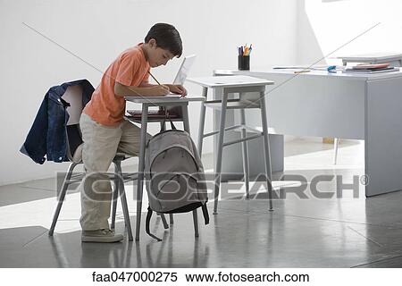 Stock Photography - Elementary school student finishing assignment. Fotosearch