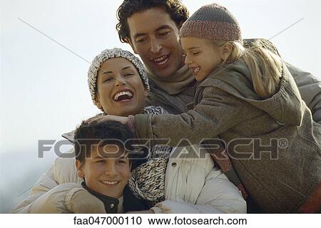 Family laughing together outdoors, daughter ruffling her brother's hair View Large Photo Image Stock Image - Family laughing together outdoors, daughter ruffling her brother's hair. Fotosearch