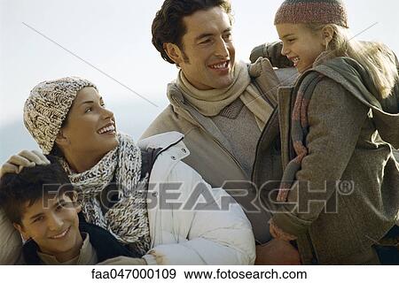 Family outdoors, father carrying daughter, mother ruffling son's hair View Large Photo Image Stock Photo - Family outdoors, father carrying daughter, mother ruffling son's hair. Fotosearch