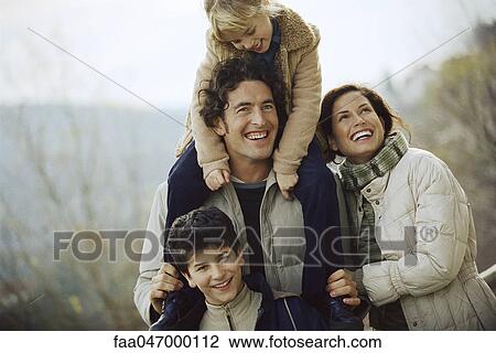 Family together outdoors, father carrying daughter on his shoulders View Large Photo Image Stock Image - Family together outdoors, father carrying daughter on his shoulders. Fotosearch