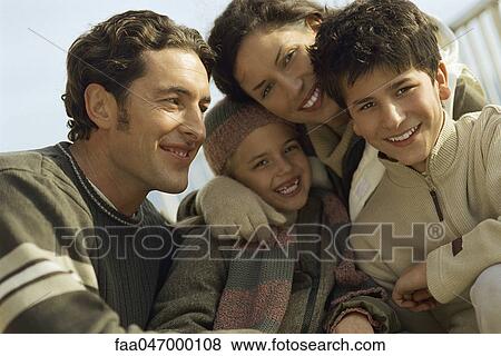 Stock Photo - Family together outdoors, man looking at son. Fotosearch