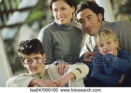 Stock Image - Family together outdoors, portrait. Fotosearch
