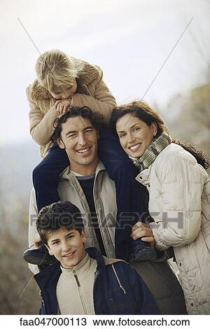 Stock Image - Family together outdoors, portrait. Fotosearch