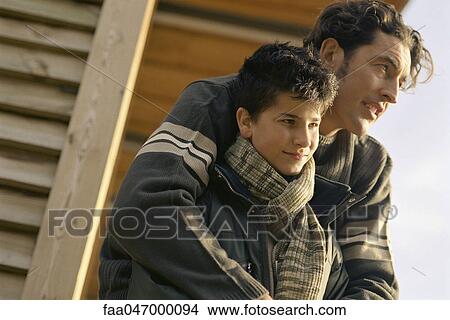 Picture - Father embracing son outdoors. Fotosearch