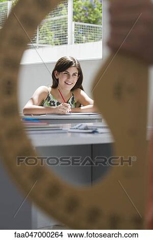 Female high school student in class, protractor in foreground View Large Photo Image Picture - Female high school student in class, protractor in foreground. Fotosearch