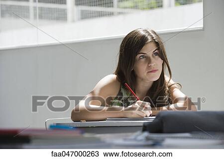 Stock Image - Female high school student in class. Fotosearch