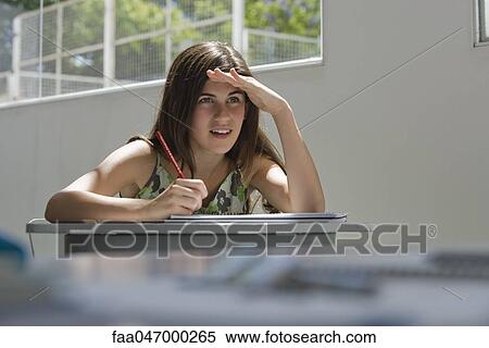 Stock Photography - Female high school student squinting. Fotosearch