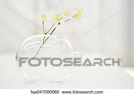 Stock Image - Flowers in piggy bank. Fotosearch