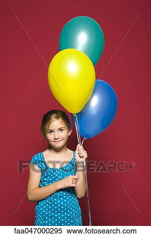 Stock Photography - Girl holding balloons, portrait. Fotosearch