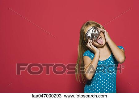 Girl wearing mask, sticking tongue out at camera, portrait View Large Photo Image Stock Image - Girl wearing mask, sticking tongue out at camera, portrait. Fotosearch