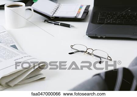 Stock Photograph - Glasses left on messy desk. Fotosearch