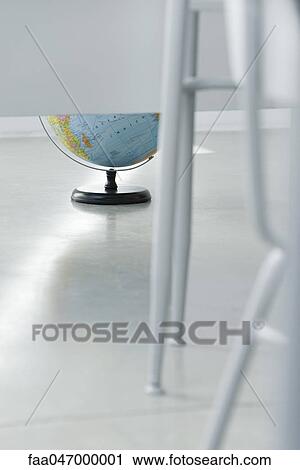 Globe on floor, partially obscured by legs of classroom furniture View Large Photo Image Stock Image - Globe on floor, partially obscured by legs of classroom furniture. Fotosearch