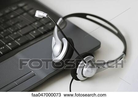 Headset and laptop computer View Large Photo Image Stock Image - Headset and laptop computer. Fotosearch