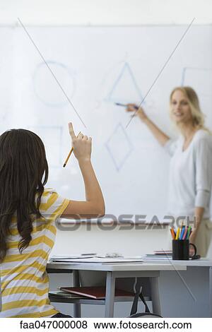 High school student raising hand, answering teacher's question View Large Photo Image Stock Photo - High school student raising hand, answering teacher's question. Fotosearch