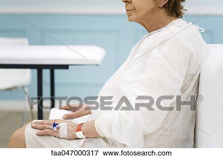 Stock Photo - Hospital patient receiving treatment, side view, cropped. Fotosearch