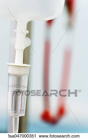 Stock Image - IV drip, close-up of drip chamber. Fotosearch