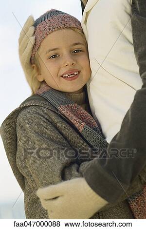 Little girl embracing parent, portrait View Large Photo Image Stock Photo - Little girl embracing parent, portrait. Fotosearch