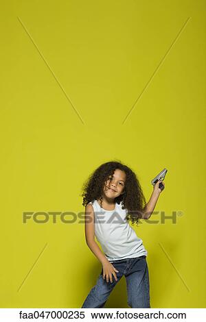 Stock Photography - Little girl posing with toy gun. Fotosearch