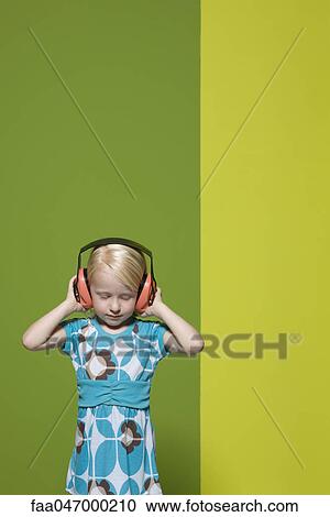 Little girl with eyes closed wearing protective headphones View Large Photo Image Stock Image - Little girl with eyes closed wearing protective headphones. Fotosearch