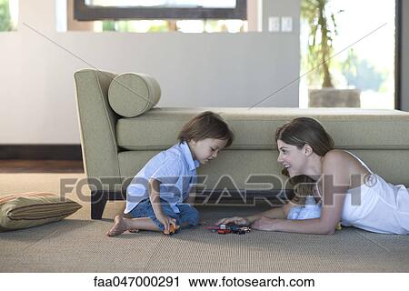 Mother and child playing with toy cars View Large Photo Image Stock Image - Mother and child playing with toy cars. Fotosearch