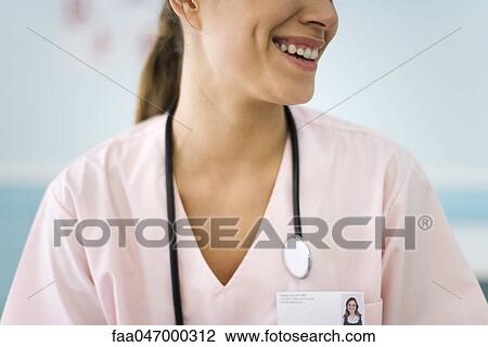 Stock Image - Nurse smiling, cropped. Fotosearch