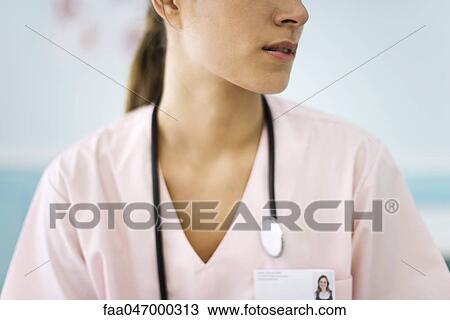 Stock Image - Nurse turning head, cropped. Fotosearch