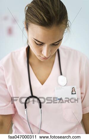 Stock Image - Nurse with head down. Fotosearch
