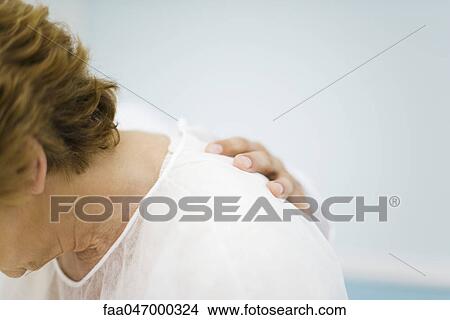 Picture - Patient being consoled by doctor, head down, cropped. Fotosearch