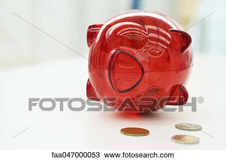 Piggy bank lying on side, coins nearby View Large Photo Image Stock Image - Piggy bank lying on side, coins nearby. Fotosearch