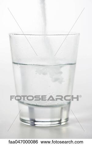 Pouring powdered medicine into glass of water View Large Photo Image Stock Photograph - Pouring powdered medicine into glass of water. Fotosearch