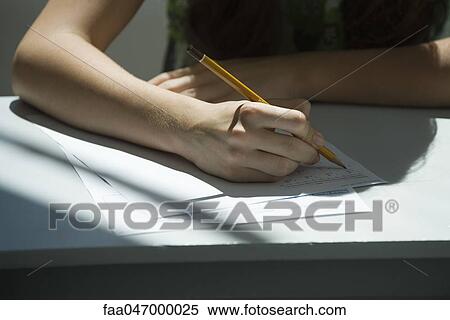 Stock Photography - Student taking math quiz, cropped. Fotosearch