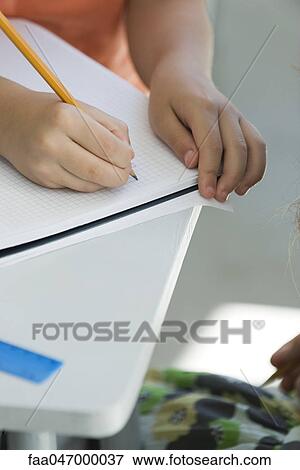 Student writing on graph paper, cropped View Large Photo Image Stock Photo - Student writing on graph paper, cropped. Fotosearch