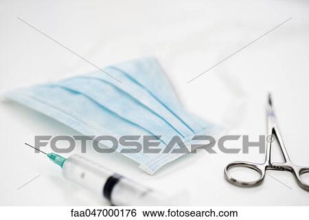 Stock Photograph - Surgical mask, syringe, forceps. Fotosearch