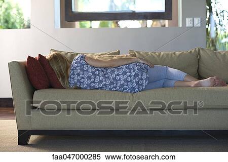 Young woman napping on sofa, rear view View Large Photo Image Stock Photography - Young woman napping on sofa, rear view. Fotosearch