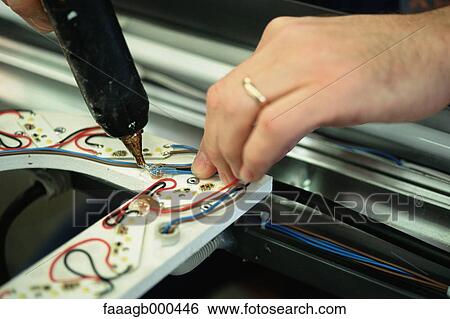 Affixing electrical wires with glue gun View Large Photo Image Stock Photograph - Affixing electrical wires with glue gun. Fotosearch