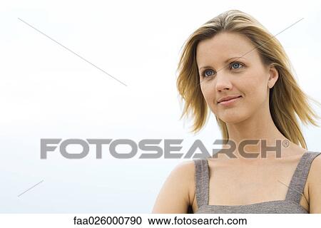 Blonde woman smiling, hair blowing in breeze, head and shoulders View Large Photo Image Stock Image - Blonde woman smiling, hair blowing in breeze, head and shoulders. Fotosearch