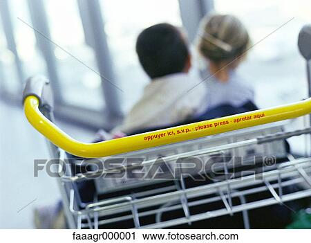 Boy and girl sitting on end of luggage rack, rear view View Large Photo Image Stock Image - Boy and girl sitting on end of luggage rack, rear view. Fotosearch
