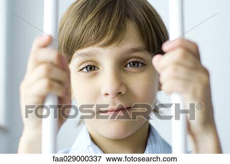 Boy behind bars, smiling at camera, portrait View Large Photo Image Stock Photo - Boy behind bars, smiling at camera, portrait. Fotosearch
