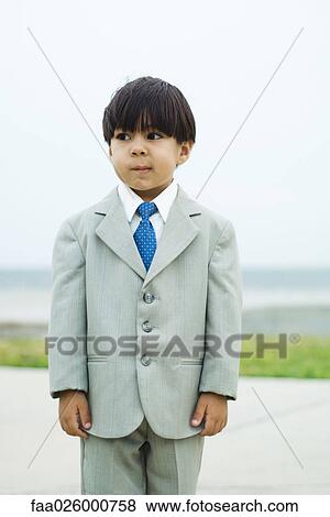 Boy dressed in full suit, twisting mouth, looking away, three quarter length View Large Photo Image Stock Photo - Boy dressed in full suit, twisting mouth, looking away, three quarter length. Fotosearch