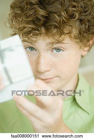 Boy holding up present View Large Photo Image Stock Image - Boy holding up present. Fotosearch