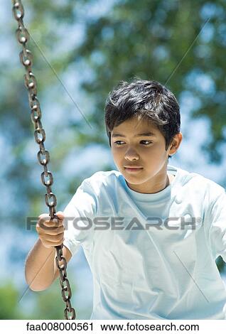Boy on swing View Large Photo Image Stock Image - Boy on swing. Fotosearch