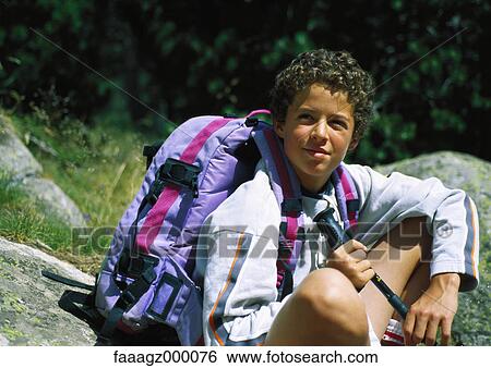 Boy resting during hike View Large Photo Image Stock Photograph - Boy resting during hike. Fotosearch