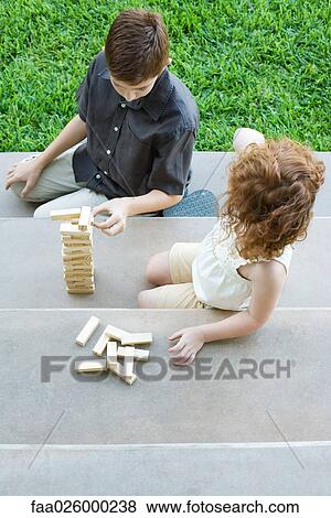 Brother and sister playing with blocks on steps, high angle view View Large Photo Image Stock Photo - Brother and sister playing with blocks on steps, high angle view. Fotosearch