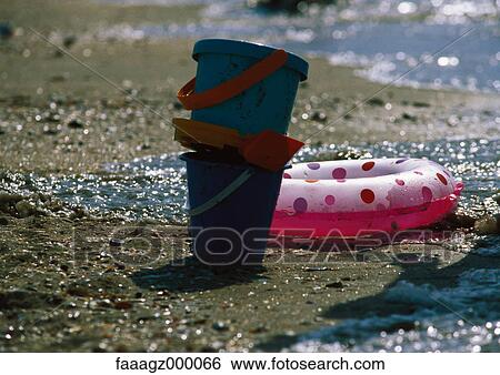 Buckets and inflatable ring on beach View Large Photo Image Stock Photograph - Buckets and inflatable ring on beach. Fotosearch