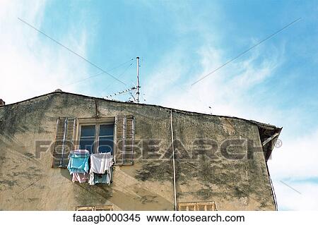 Building with laundry drying at window View Large Photo Image Stock Photography - Building with laundry drying at window. Fotosearch