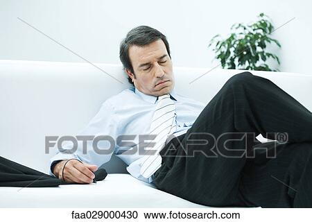 Businessman asleep on couch View Large Photo Image Stock Image - Businessman asleep on couch. Fotosearch