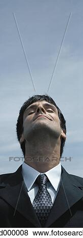 Stock Photo - Businessman outdoors with eyes closed. Fotosearch